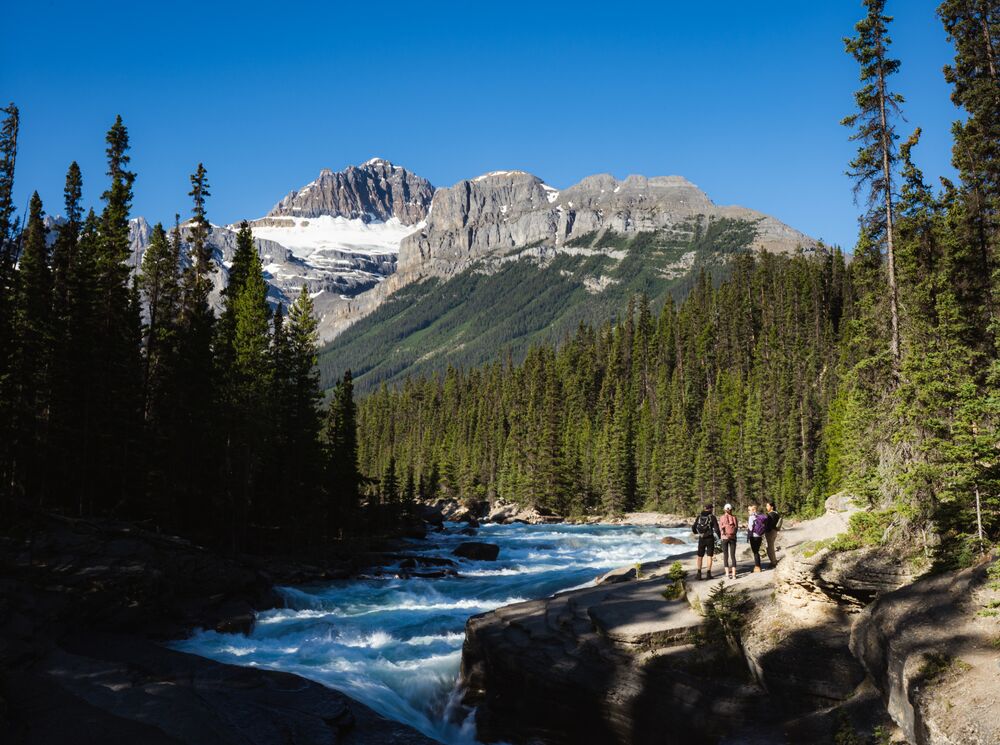 Friends exploring Mistaya Canyon on the Icefield Parkway in Banff National Park.